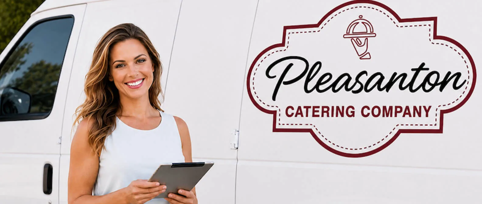Pleasanton Catering Company — catering coordinator reviewing the order at the branded delivery van ahead of a Tri-Valley drop-off in Pleasanton, Dublin, Livermore, and San Ramon Pleasanton Catering Company event coordinator holding a tablet beside the branded white Pleasanton Catering Company van before a drop-off catering delivery in Pleasanton, CA