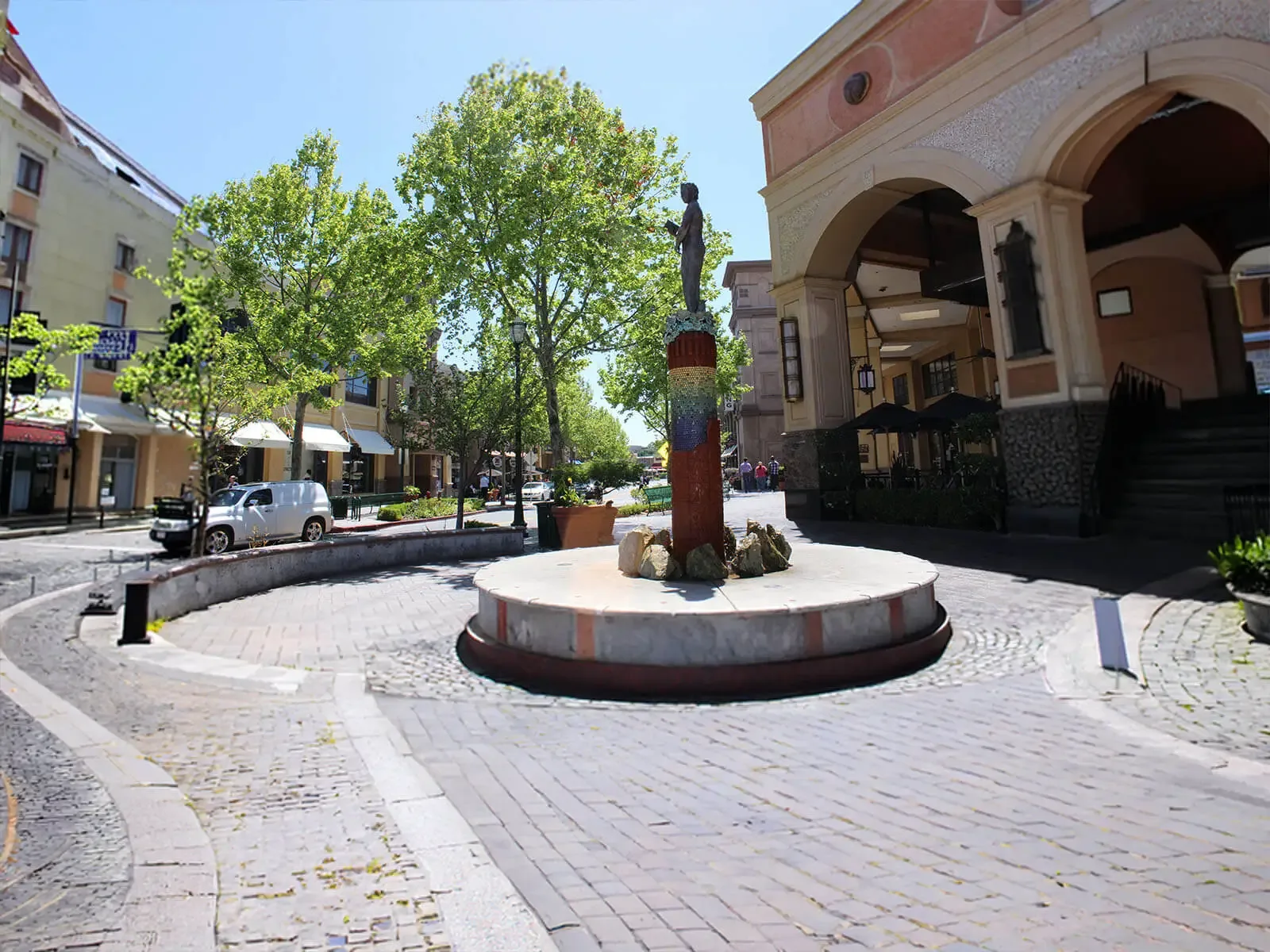 Walnut Creek Catering Company — full-service catering near downtown venues around Broadway Plaza, with on-site staff, setup, chef-attended service and cleanup in Walnut Creek, Danville, Alamo, Lafayette, Orinda, Pleasant Hill and Concord Cobblestone plaza with the mosaic sculpture column, sycamore trees and arched storefronts at Broadway Plaza in downtown Walnut Creek, California — the Contra Costa area served by Walnut Creek Catering Company