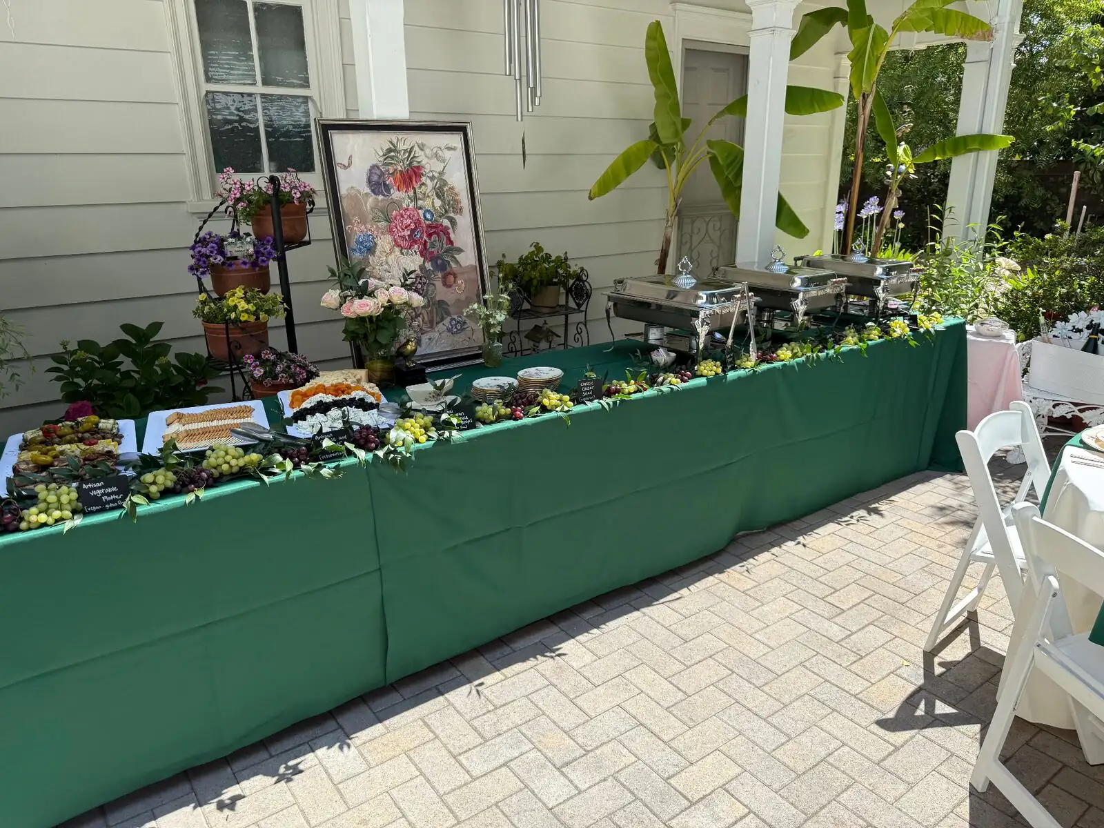 Full-service catering with attendants, chafing dishes, and floral tablescape in Tracy