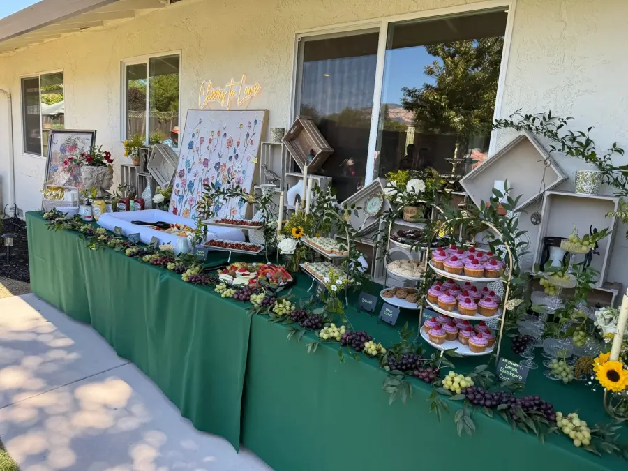 Bridal shower dessert and grazing tablescape with cupcakes, grapes and soft draping — shower styling for Tracy and Brentwood events